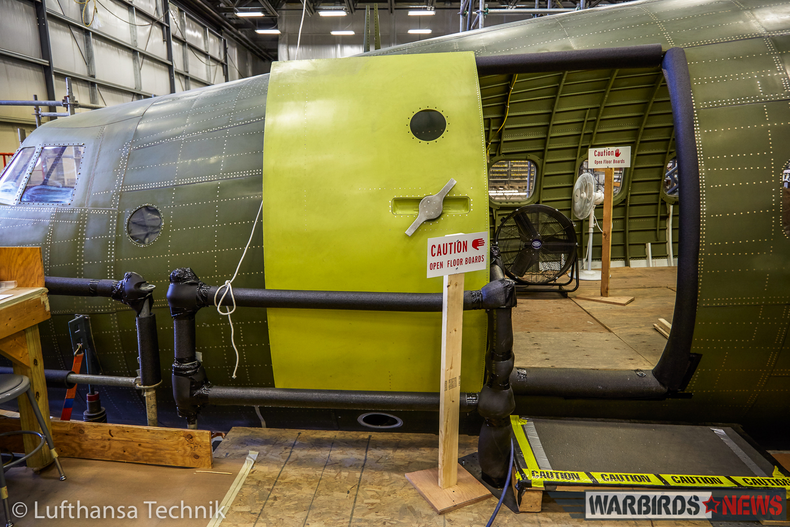 Lufthansa Lockheed L-1649A Super Star Restoration - Part 2 13 One of the freshly-rebuilt fuselage doors going back on the aircraft. (© Lufthansa Technik)