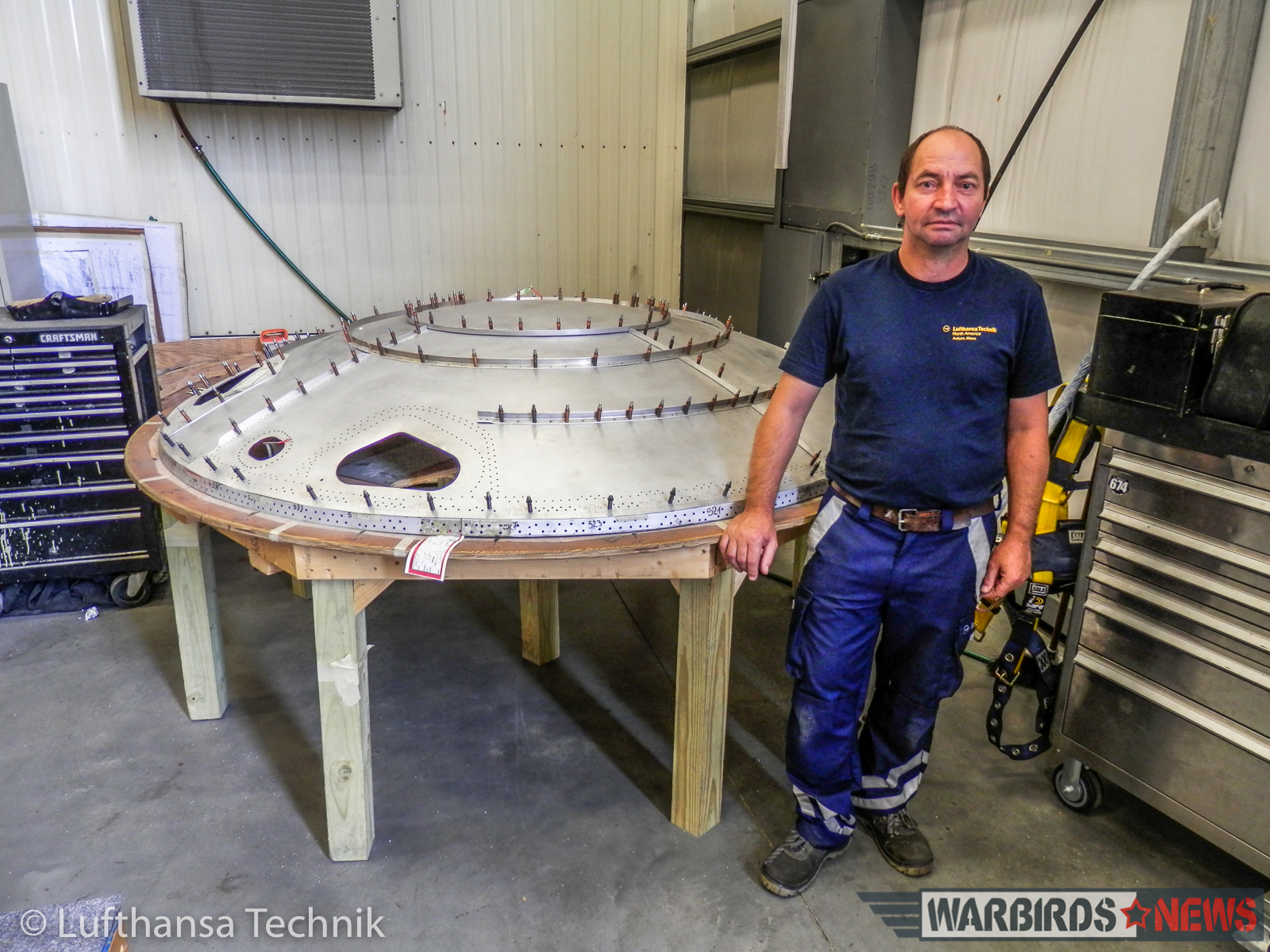 Lufthansa Lockheed L-1649A Super Star Restoration - Part 2 14 Master sheet metal specialist, Gyula Nagy of Lufthansa Technik Budapest standing in front of the rear fuselage pressure bulkhead he remanufactured in Lewiston, Maine. (© Lufthansa Technik)