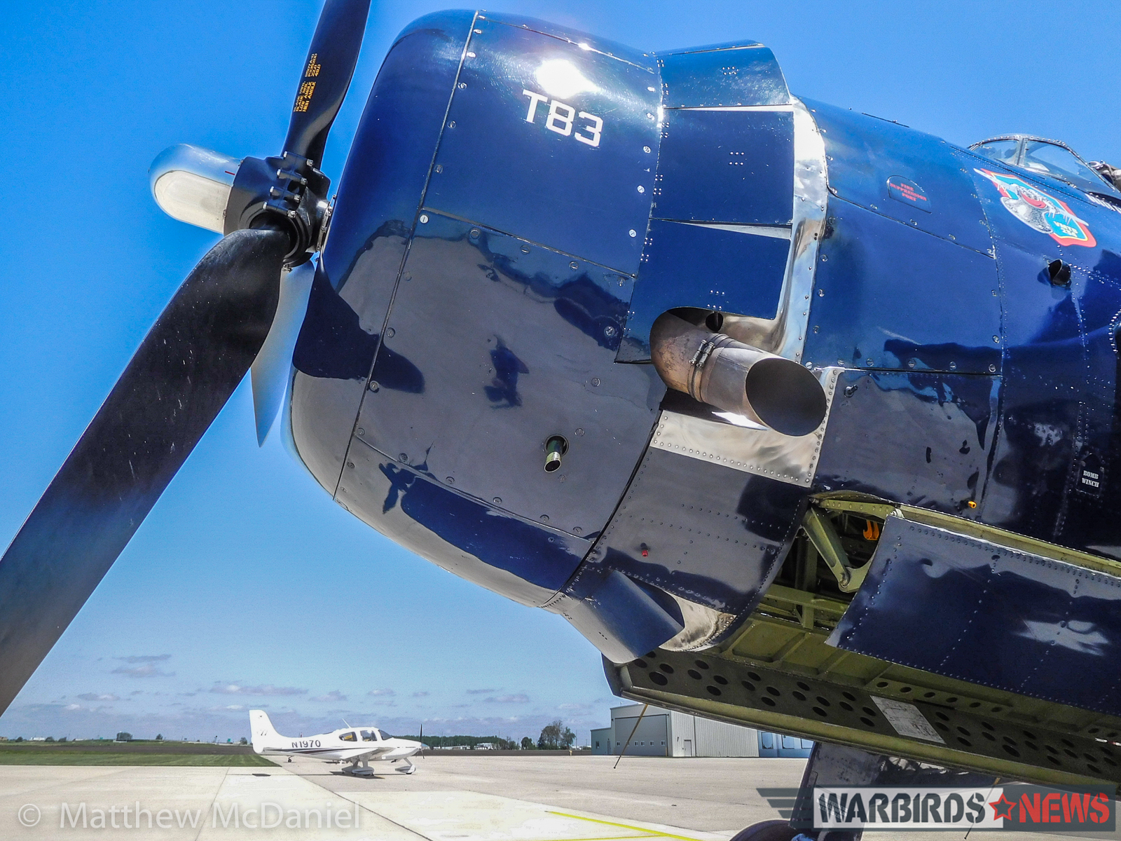 Turkey Wrestling - Flying the TBM Avenger 11 The nose of the Avenger towers above the author's ride to the event (a Cirrus SR-22). The massive cowl flaps encircling the TBM's nose can increase ground roll by 30% if left open during takeoff. (Photo by Matthew McDaniel)