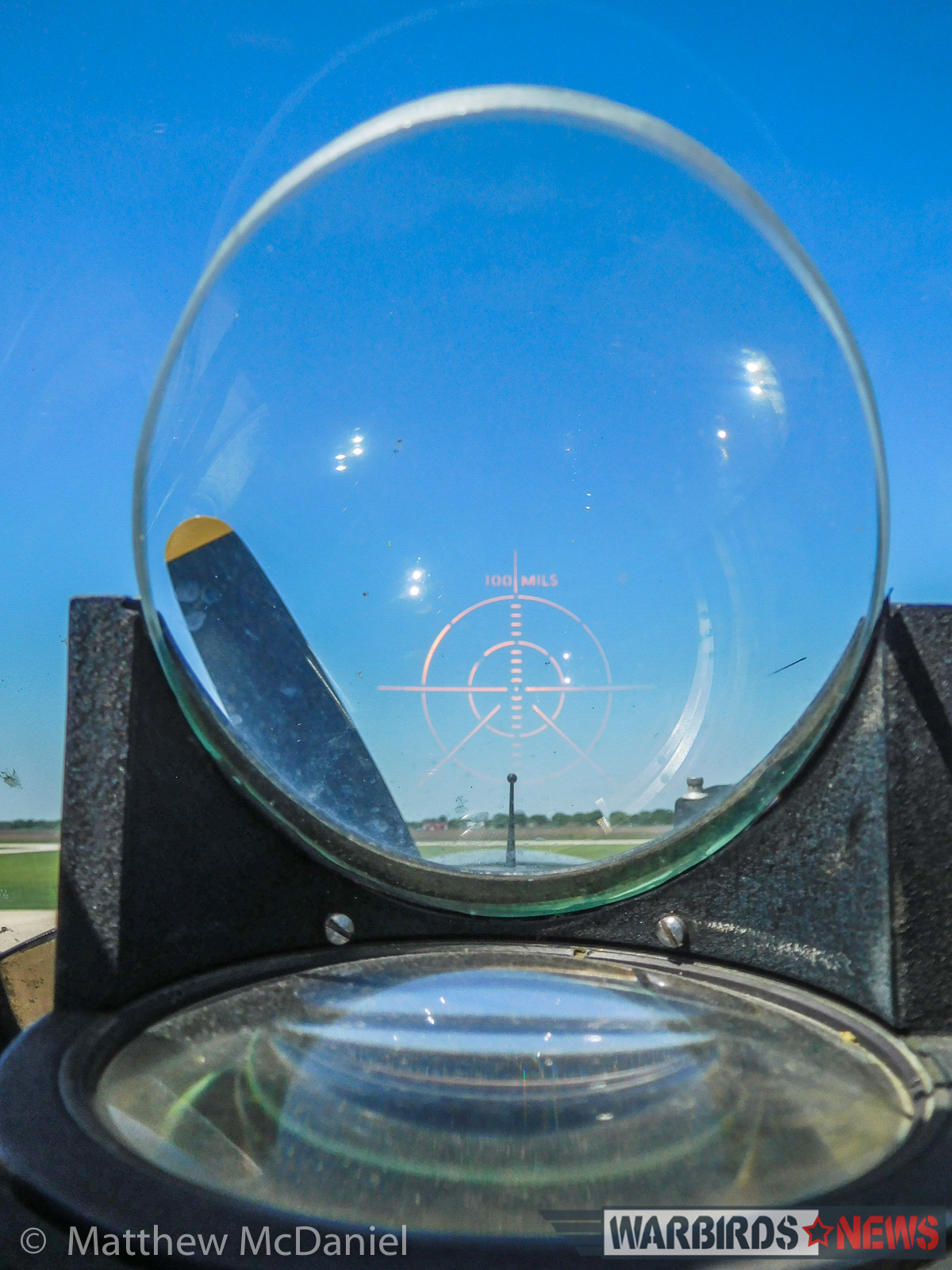 Turkey Wrestling - Flying the TBM Avenger 20 Deckert is understandably proud of the functional, electric, glass-projection, gun site. It was the WWII-technology version of a Head's Up Display (HUD). It's skewed alignment is due to the resting angle of the big taildragger on the ground. (Photo by Matthew McDaniel)