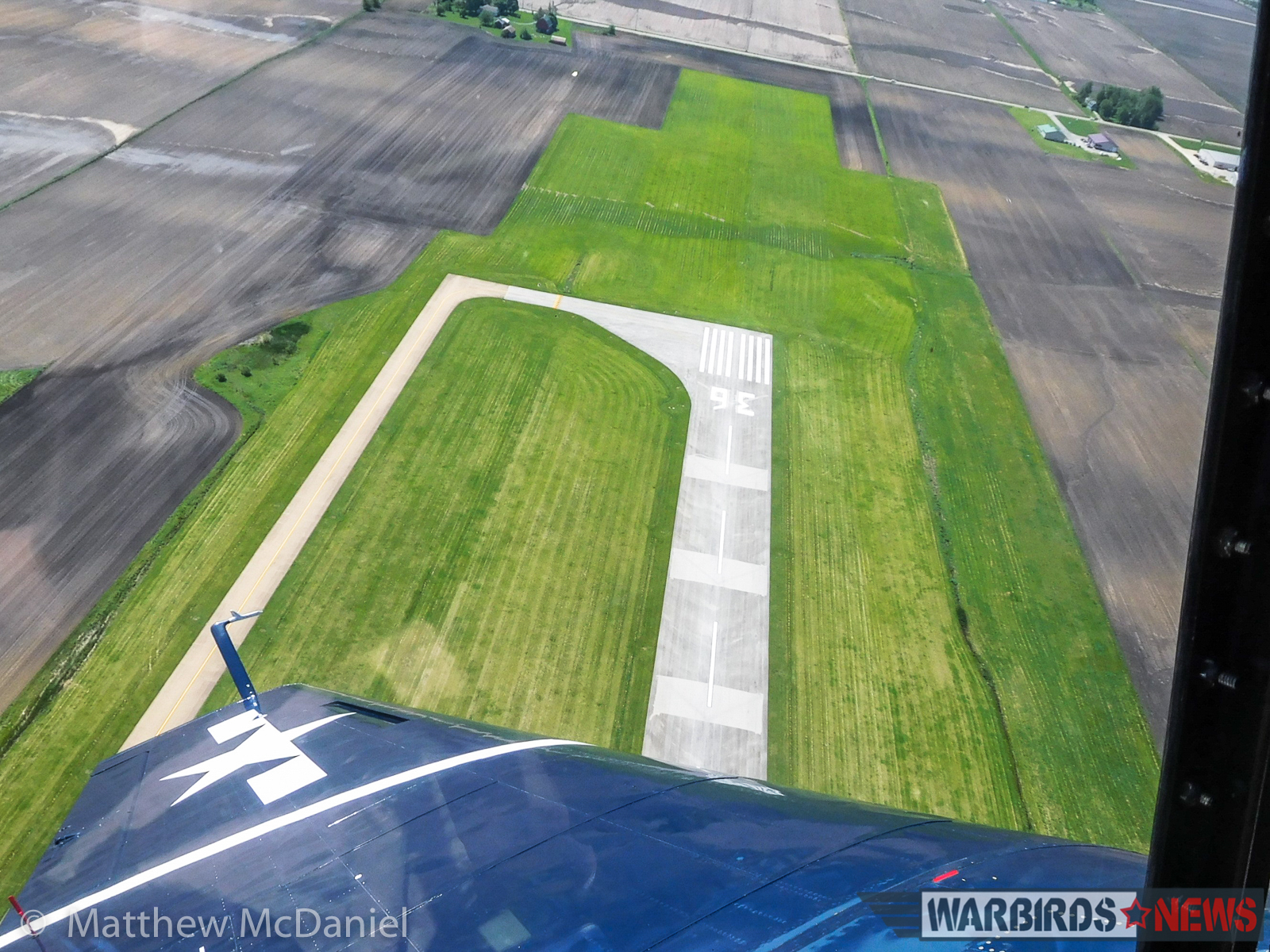 Turkey Wrestling - Flying the TBM Avenger 27 Looking down at the approach end of VYS's runway 36, during a left overhead break for landing on Runway 25. (Photo by Matthew McDaniel)