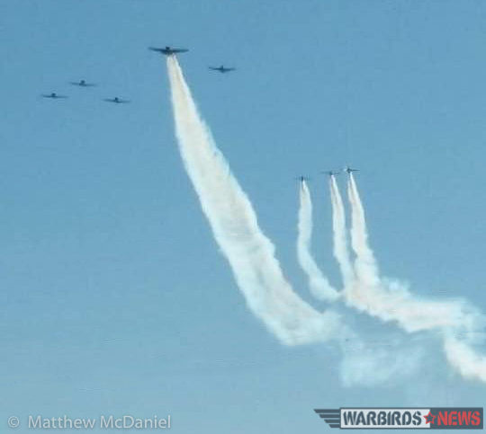 Turkey Wrestling - Flying the TBM Avenger 26 Deckert's TBM leads a formation of several warbird trainer types, showing off a smoke system that dwarfs that of the adjacent Yak trainers. Although this is a very rough image it's all the author had that showed the TBM's smoke in direct comparison to other warbirds...it is hard to appreciate it otherwise. (Photo by Matthew McDaniel)