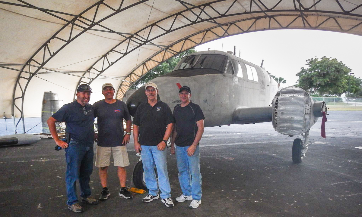 138th Aviation Company Memorial Kickstarter Campaign 15 A group of Delta Airlines mechanics standing in front of the Ute in its temporary home at Orlando Executive Airport. These men will be part of the team volunteering their time to rebuild the Ute for the 138th Aviation Company Memorial. (photo via Andrew Rodriguez)