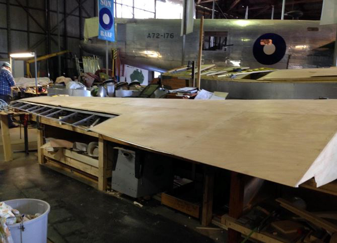 Australian Airspeed Oxford - Project Update 18 The left wing nearing completion. RAAF Liberator A72-176 can be seen in the background. (photo via B-24 Liberator Memorial Fund)
