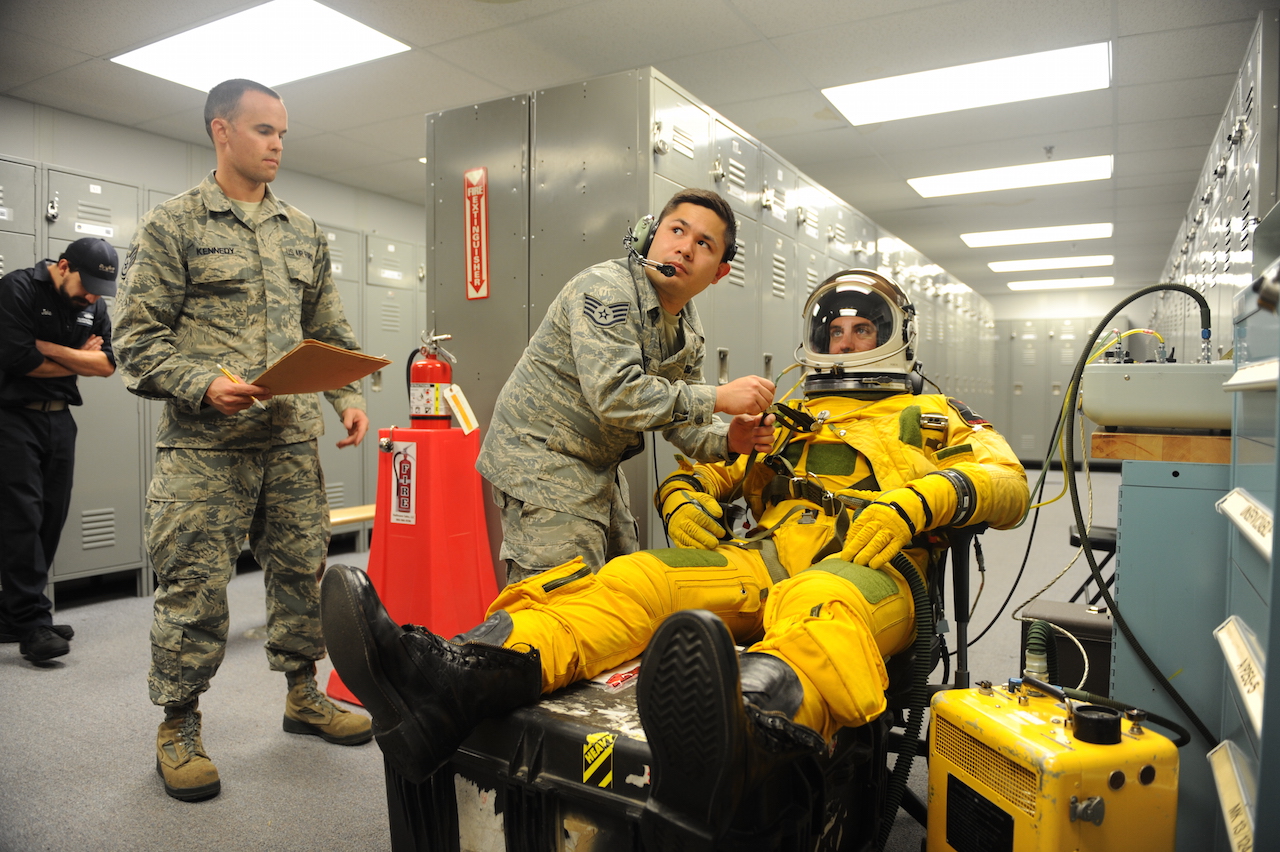 U-2 Dragon Lady Takes Center Stage During Air Force Celebrations 12 Staff Sgt. Timothy Dayrit (center), and Staff Sgt. Joseph Kennedy (left), 9th Physiological Support Squadron full-pressure suit technicians perform pre-flight full-pressure suit maintenance for Capt. Travis, 99th Reconnaissance Squadron U-2 pilot, Sep. 19, 2015, at Joint Base Andrews, Maryland. The full-pressure is worn by U-2 Dragon Lady pilots who frequently fly at the edge of space. (U.S. Air Force photo by Senior Airman Bobby Cummings/Released)