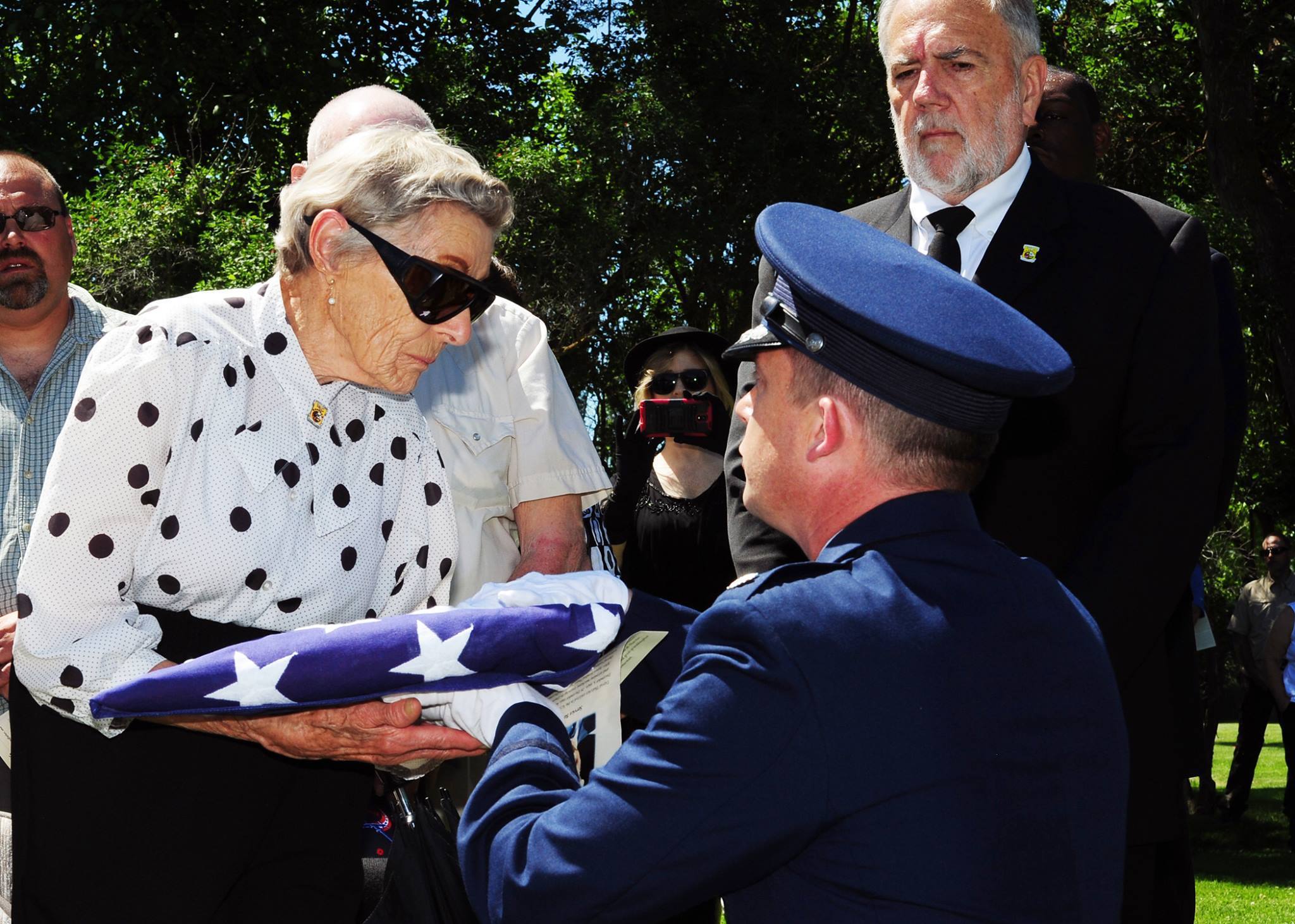 Doolittle Raider Honored 12 Lt. Col. Michael Epper, 341st Force Support Squadron commander, presents the flag to Dawn Thatcher, wife of Staff Sgt. David J. Thatcher, during a funeral service June 27 in Missoula, Mont. At 20 years old, Sgt. Thatcher was an engineer gunner in Flight Crew 7 of the Doolittle Tokyo Raids. His crew crash-landed into sea off the coast of China on April 18, 1942. Thatcher saved four members of the crew by pulling them to safety on the surrounding beach and applying life-saving medical treatment, even though he was injured himself. (U.S. Air Force photo by 2nd Lt. Annabel Monroe)