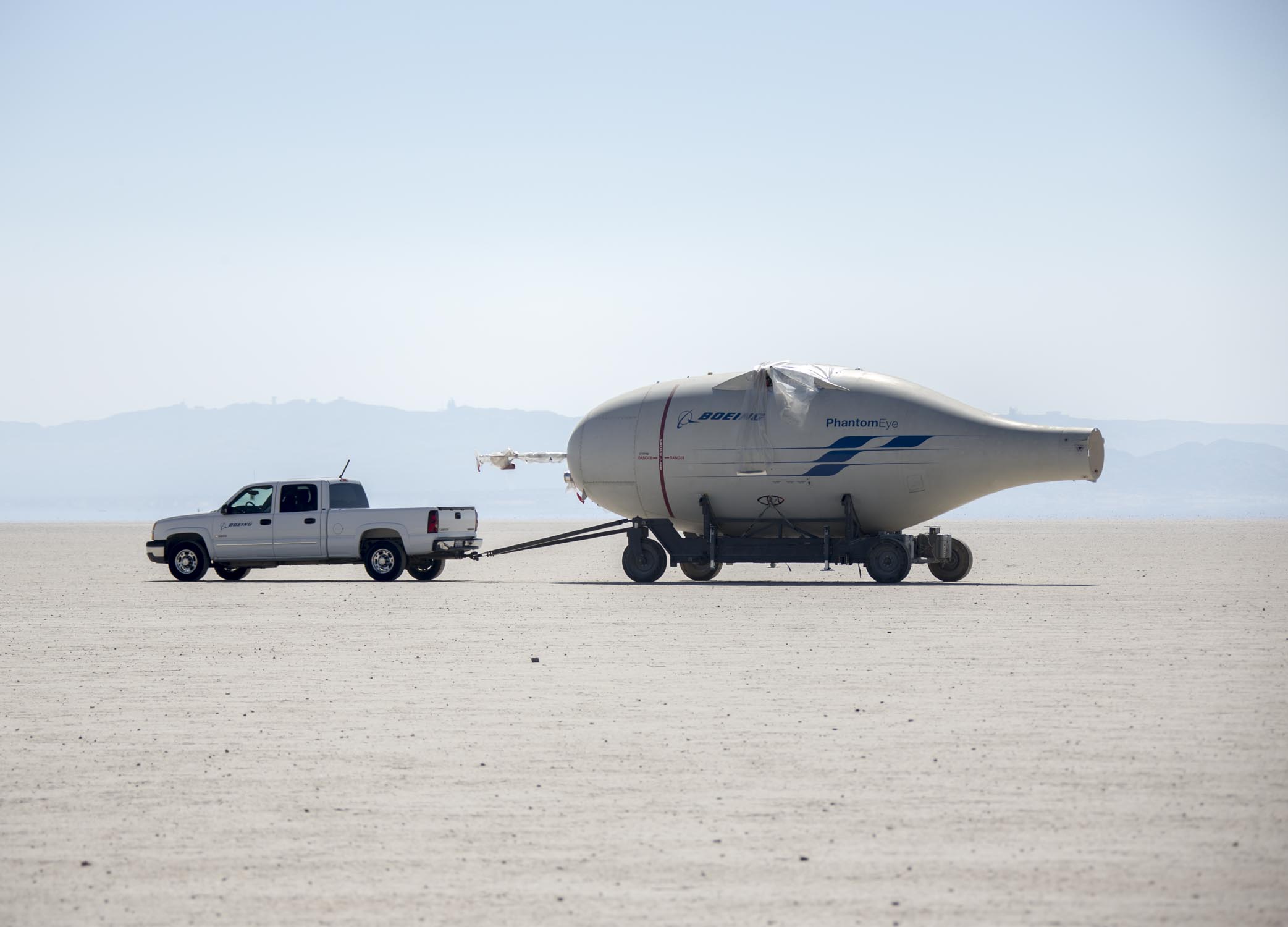 Air Force Flight Test Museum Taking in more NASA History 11 EDWARDS AIR FORCE BASE, Calif. (Aug. 17, 2016) Photos of NASA employees moving the disassembled Phantom Eye, a Boeing-developed, liquid hydrogen-powered demonstrator aircraft, during a transfer from the NASA Armstrong Flight Research Center across Rogers Dry Lake to the red-topped Hanger 4305 on North Base, where the aircraft will await reassembly and refurbishment for eventual display as part of the Air Force Flight Test Museum. Phantom Eye was designed to fly long endurance missions at high altitudes as a potential surrogate for military intelligence and communications satellites. Smoke from the Blue Cut Fire can be seen in the background of some images. (U.S. Air Force photo by Christopher Okula)