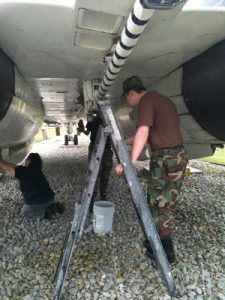 Grissom Air Museum Enlists the Public's Assistance for Aircraft Maintenance 12 Volunteers provide needed attention to the undercarriage of their adoptee. (Image Credit: GAM)