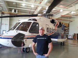 Sandbar Mitchell Project Lands a Donated Helicopter Lift 11 Happy Patrick Mihalek and the 'copter that will greatly simplify the retrieval of the Mitchell. (Image Credit: Sandbar Mitchell Restoration)