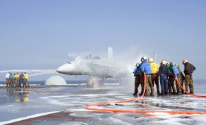 Some of the Most Important Planes on US Navy Carriers Never Fly 18 Crash and salvage teams spray an aircraft during a training exercise aboard the aircraft carrier USS George Washington (CVN 73) (Image Credit: US Navy)