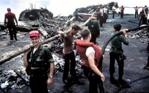 Some of the Most Important Planes on US Navy Carriers Never Fly 16 Crewmen battle the remnants of the blaze that literally burned the F-4B Phantoms in the background to the ground (Image Credit: US Navy)
