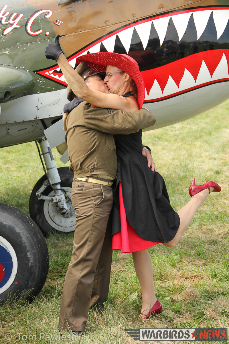 The Greatest Show on Turf 2017 - Geneseo Air Show Report 14 A pair of WWII re-enactors share a bit of romance in front of the Warhawk... and why not indeed? (Photo by Tom Pawlesh)