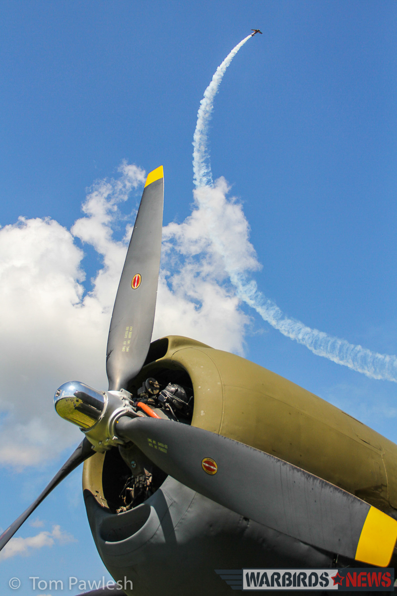 The Greatest Show on Turf 2017 - Geneseo Air Show Report 24 A glorious composition of an aerobatics display above the C-46's engine. (Photo by Tom Pawlesh)