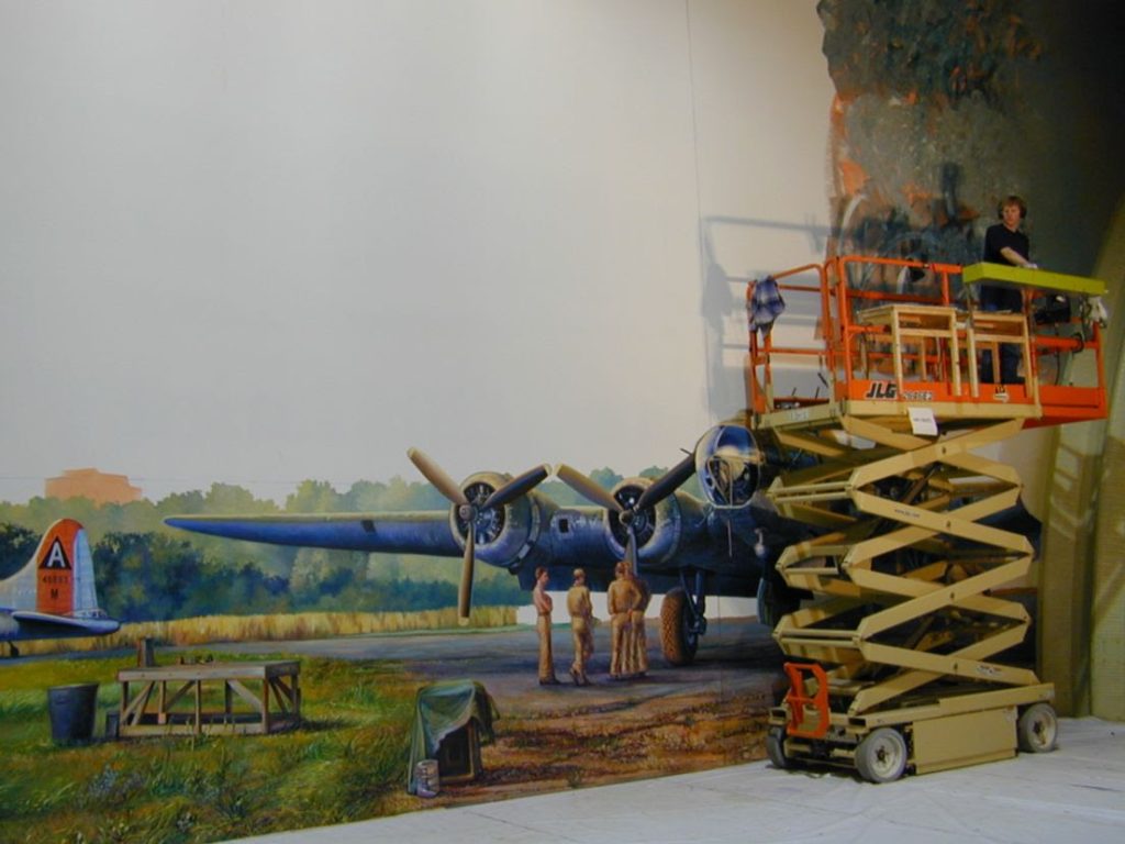 Air Zoo Aerospace & Science Center to Host Annual Science Innovation Awards and 2025 Michigan Aviation Hall of Fame Induction 10 2025 MAHOF enshrinee Rick Herter works on the worlds largest indoor mural at the Air Zoo on March 22 2004. Photo courtesy of the Air Zoo