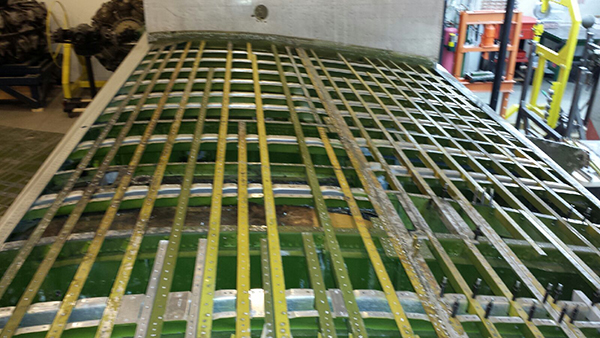 Sandbar Mitchell Project Update 11 We have drilled out both the forward and aft upper wing panel rivets and removed the panels to expose the inner workings of the center section. We received 48 rolls of 35mm microfilm from the Smithsonian Archives containing all of the B-25's production engineering drawings. We still need to order the drawings for the late TB-25 Hayes modifications. We are hoping to convert the Microfilm into searchable PDF files. (photo via Sandbar Mitchell Project)