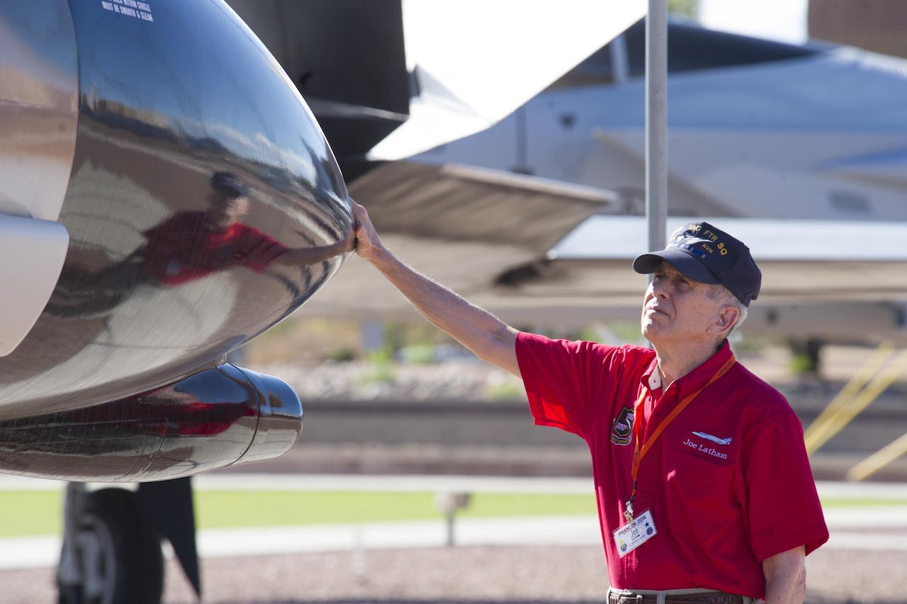F-4 Pilot, MiG-21 Destroyer, Tells Story 13 Col. (Ret.) Joe Latham, previously an F-4 Phantom pilot from Holloman Air Force Base, N.M., stops Sept. 13, 2016, to reminisce next to the F-4 adorned with his name Sept. 13, 2016, at Holloman AFB’s Heritage Park. Latham’s visit was part of Holloman’s annual Phantom Society Tour where 160 aircraft enthusiasts, including veterans and non-veterans with aviation backgrounds, visit various base locations. The tour included an F-16 Fighting Falcon briefing and static display, travel to Holloman’s High Speed Test Track, the opportunity to view QF-4s and F-16s in flight, and a visit to Heritage Park to view displays of various aircraft historically stationed at Holloman AFB. (U.S. Air Force photo by Master Sgt. Matthew McGovern)