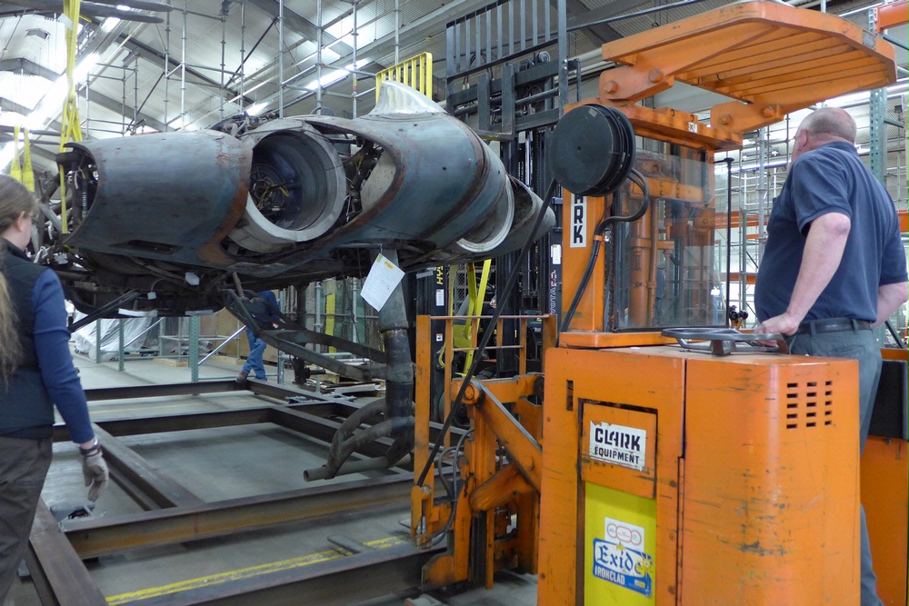 Horten Flying Wing Heading to NASM's Udvar-Hazy Center 12 Jennifer Stringfellow (left) keeps a close eye on proceedings, calling out adjustments to Rob on the forklift as he positions the Horten on the steel frame. (Lauren Horelick photo via NASM)