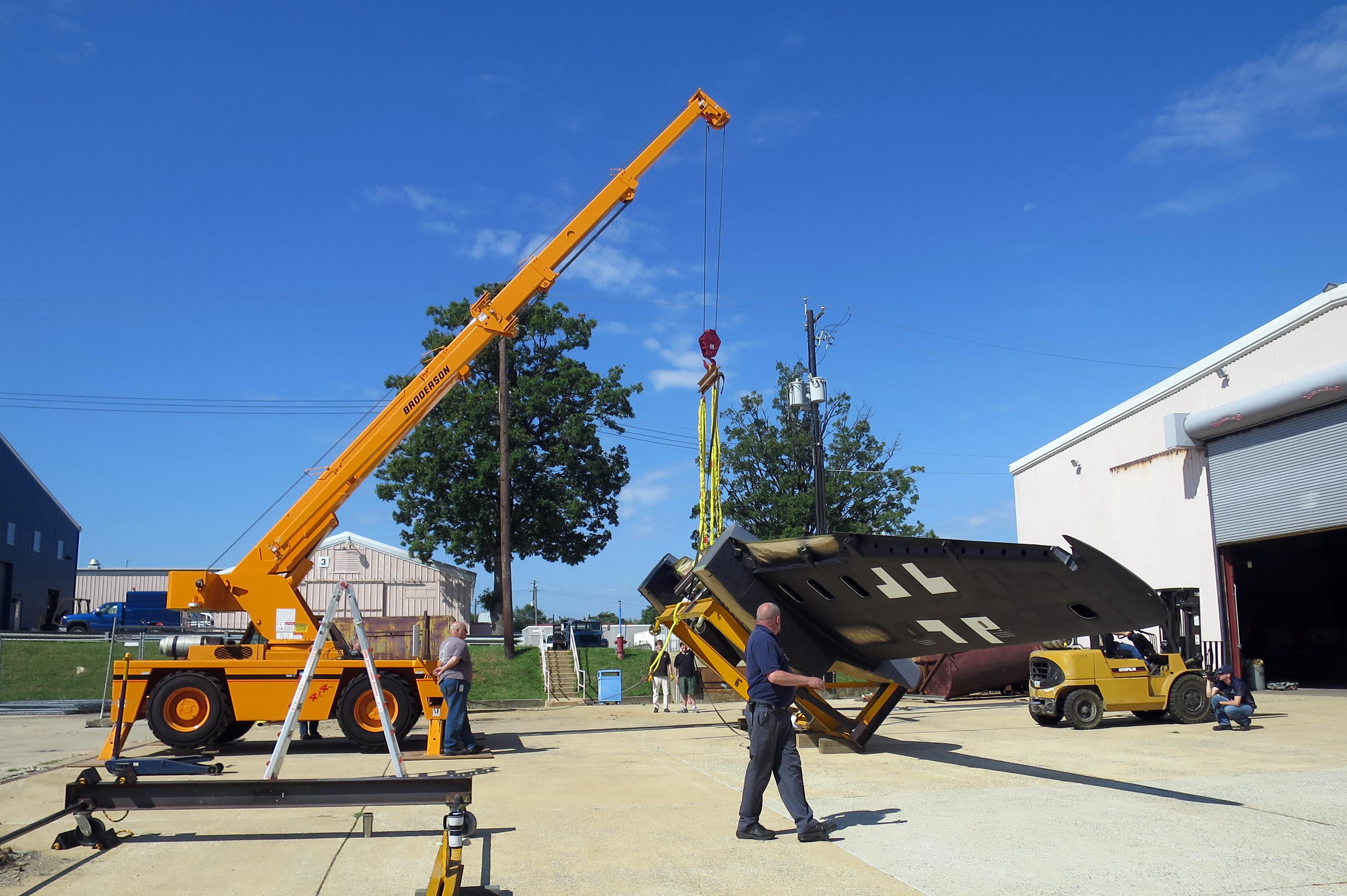 NASM's Heinkel He-219 Restoration Update 14 After removing the first stand, heavy equipment is employed in rotating the wing 90°. Patiently and precisely, all equipment is put in place, and two staff members act as true “wingmen,” closely watching the wing as it is rotated. (photo via NASM)