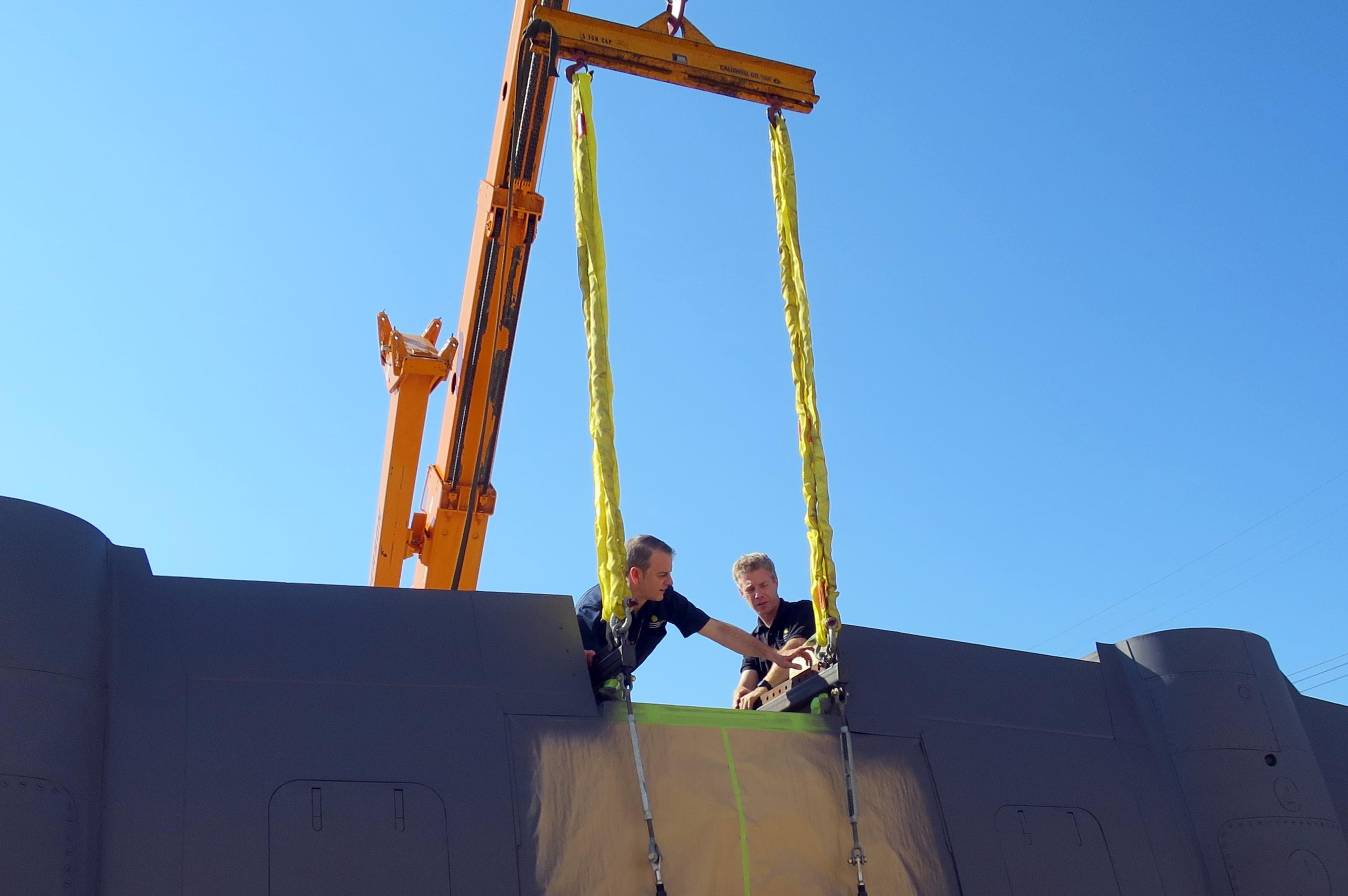 NASM's Heinkel He-219 Restoration Update 13 To lift the wing from the first stand, straps are attached to the wing lifting fixtures. Here, Dave Wilson and Tony Carp check the position of these straps. (photo via NASM)