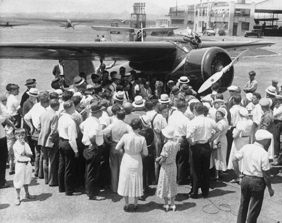 Today in Aviation History: Amelia Earhart Begins Non-Stop Transcontinental USA Flight 12 A small crowd gathers around Amelia Earhart and her Lockheed Model 5B Vega at Newark Municipal Airport 25 August 1932