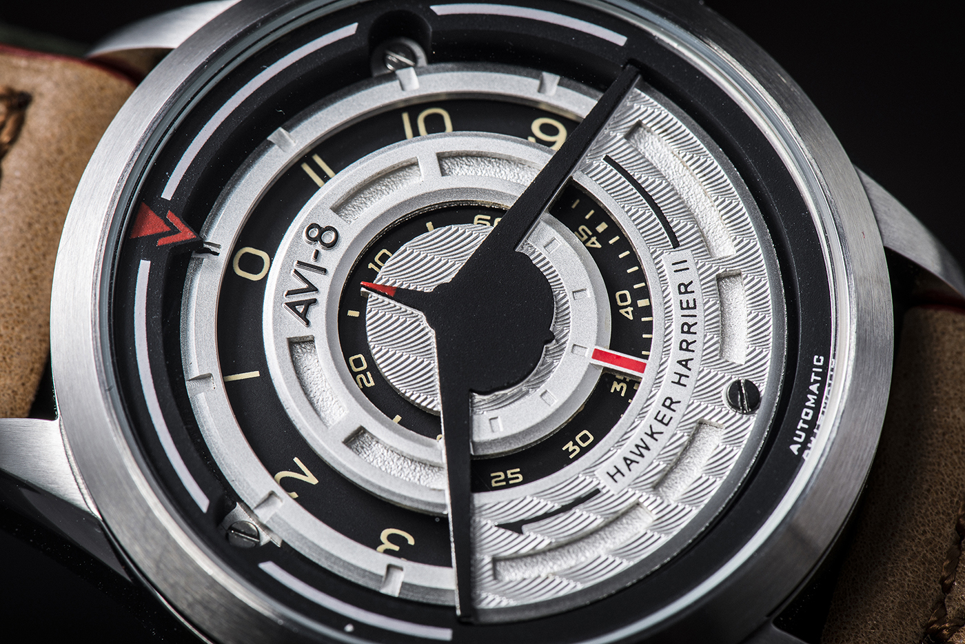 Introducing the AVI-8 Harrier II Timepiece 13 A close-up view of the watch dial clearly shows the Harrier silhouette in black on the front, and how it subtly indicates the time with the rotating discs displaying the hour, minute and second.