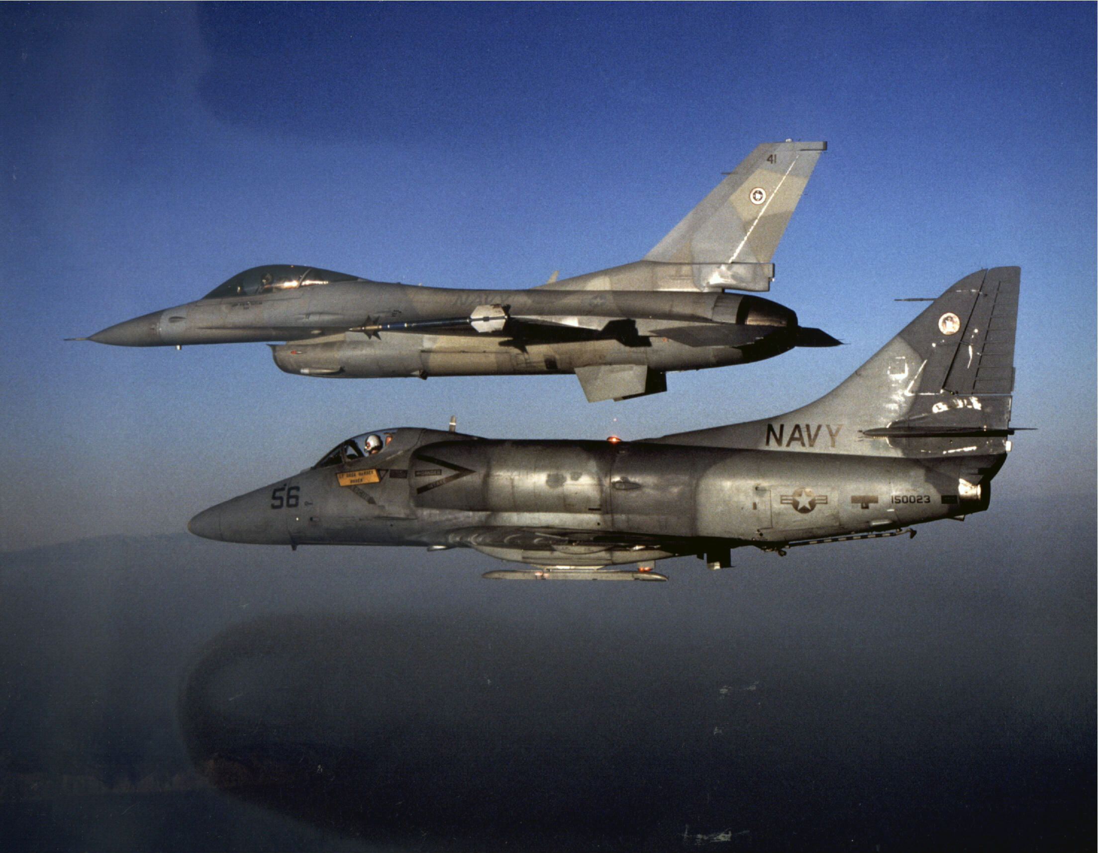 The Legacy of Top Gun 13 An A-4E Skyhawk (foreground) and F-16N Viper, both assigned as aggressor aircraft at the Navy Fighter Weapons School (TOPGUN) pictured in flight near San Clemente Island off the coast of California in 1989. (Robert L. Lawson Photograph Collection, National Naval Aviation Museum)