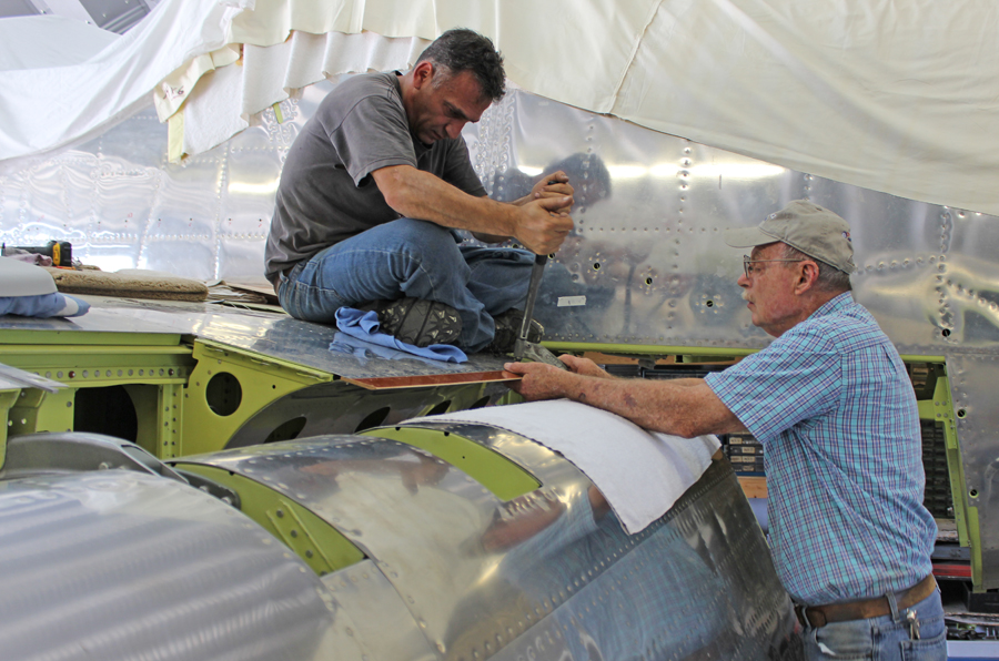 XP-82 Twin Mustang - May, 2015 - Restoration Update 12 Tom Reilly (r) with Ayman installing the phenolic rub-strip for the flap. (photo via Tom Reilly)