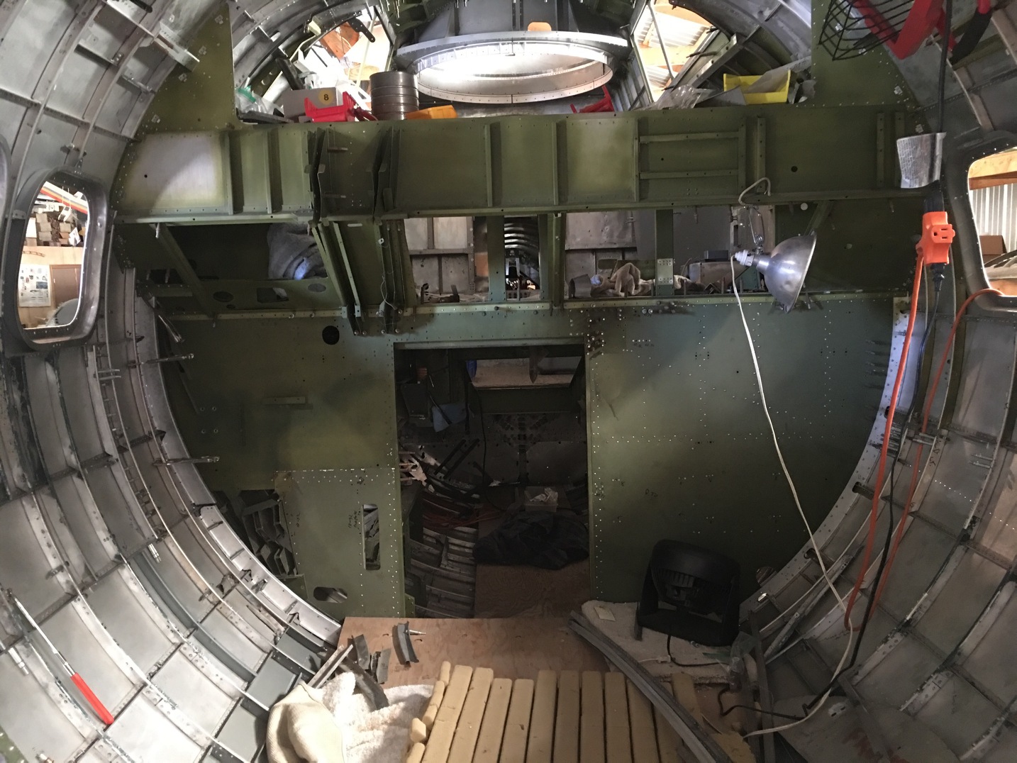 B-17E “Desert Rat” - October 2017 Restoration Update 16 An interior view of Desert Rat's nose section looking back towards the cockpit. The small lower bulkhead opening is the entry point for the nose. It is a tight squeeze at the best of times, but imagine getting through that hole in a hurry while wearing a bulky fleece-lined flight suit. It's no surprise that crew members had a near impossible task exiting this area during an emergency! (photo via Vintage Aviation Museum)