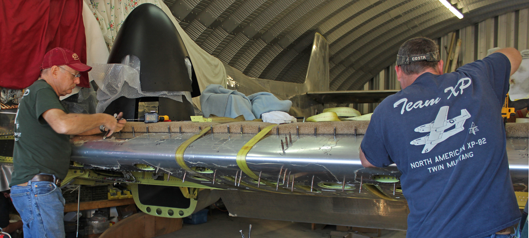 XP-82 Twin Mustang - December 2015 - Restoration Update 12 Fitting the center wing leading edge assembly to the main spar. Note one of the huge propeller spinners on the left hand side. (photo via Tom Reilly)