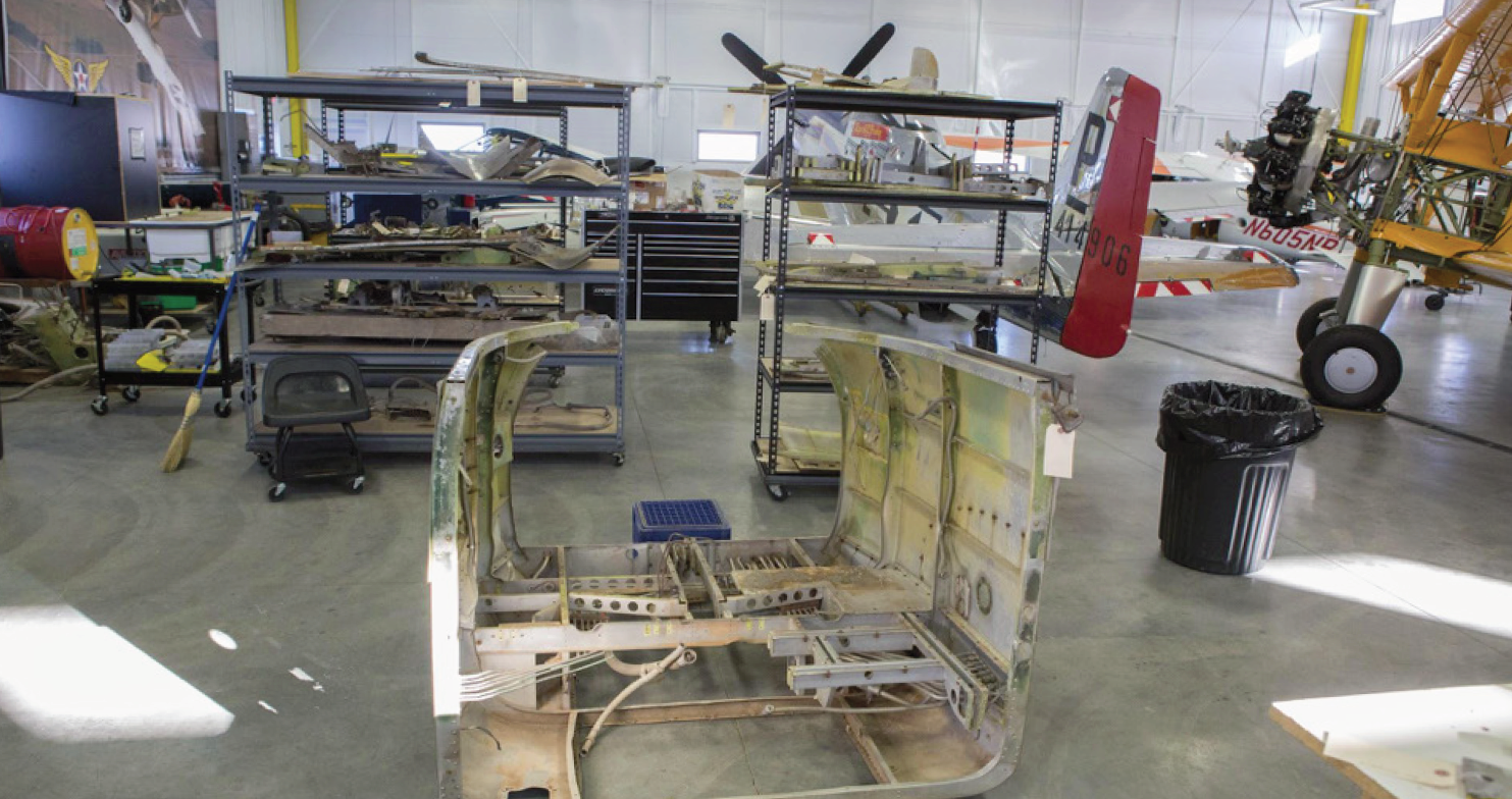 Cadet Air Corps Museum AT-10 Restoration Project 18 One of the “donor” sections shows here. Behind it is the P-51D, Cripes A’Mighty and Wings of the North’s N2S-1 Stearman BuNo 3347, once flown by George H.W. Bush in training at Minneapolis Naval Air Station.