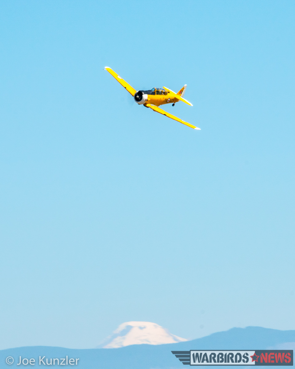 Props & Ponies at the Heritage Flight Museum - Air Show Report 27 A Canadian Harvard banking with Mt. Baker in the background, just before roaring down the runway on a low approach. (photo by Joe Kunzler)