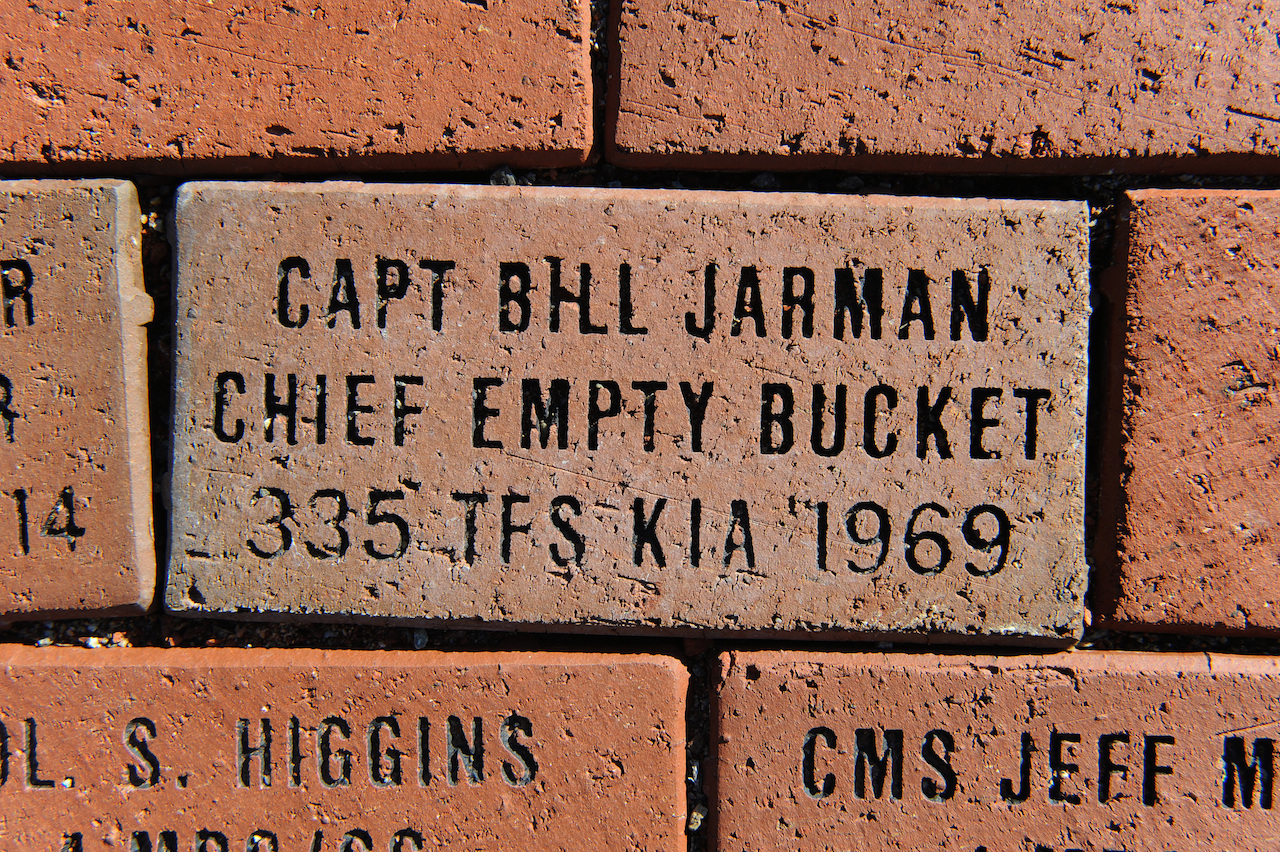 Keeping a Memory Alive: Family Honors Lost Loved One, 4th FW Hero. 11 A brick dedicated to Capt. William Jarman Jr., an F-4 Phantom pilot with the 335th Tactical Fighter Squadron during the 1960s, who died in 1969 during an aircraft collision over Fort Bragg, N.C., lays in Heritage Park at Seymour Johnson Air Force Base, N.C., Nov. 14, 2014. Two bricks are inscribed with his name and service details. Bricks surround the Heritage Park F-15E Strike Eagle memorial fountain, commemorating heroes from the base's past. (U.S. Air Force photo/Airman 1st Class Aaron Jenne)