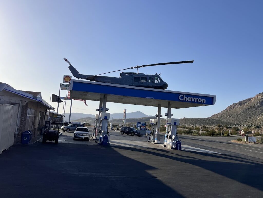 A Stroke of Marketing Genius: Local Businesses, Vintage Aircraft, And Their Unusual Association 34 Chevron gas station with a Bell UH 1 Iroquois Adam Estes