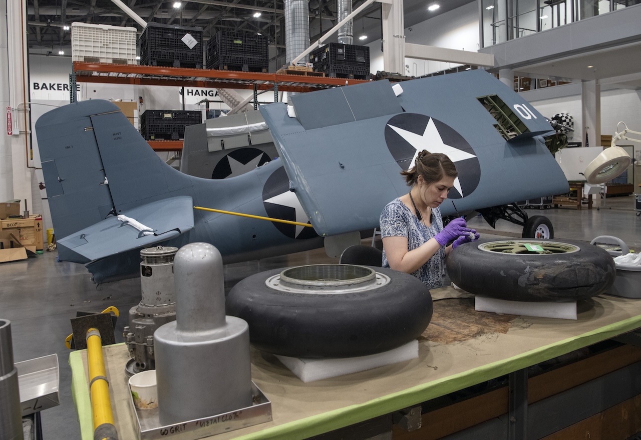 National Air and Space Museum Prepares for a New WWII Gallery 15 Conservator Maggie Bearden treats the tires for the Eastern Division FM 1 Wildcat in the Mary Baker Engen Restoration Hangar Smithsonian photo by Mark Avino