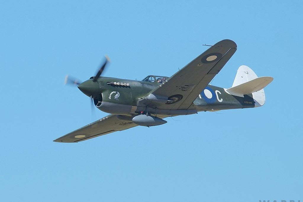 Curtiss Kittyhawk to Fire its Main Armament at Warbirds Over Wanaka 2022 10 Curtiss P 40N Kittyhawk flying in blue sky