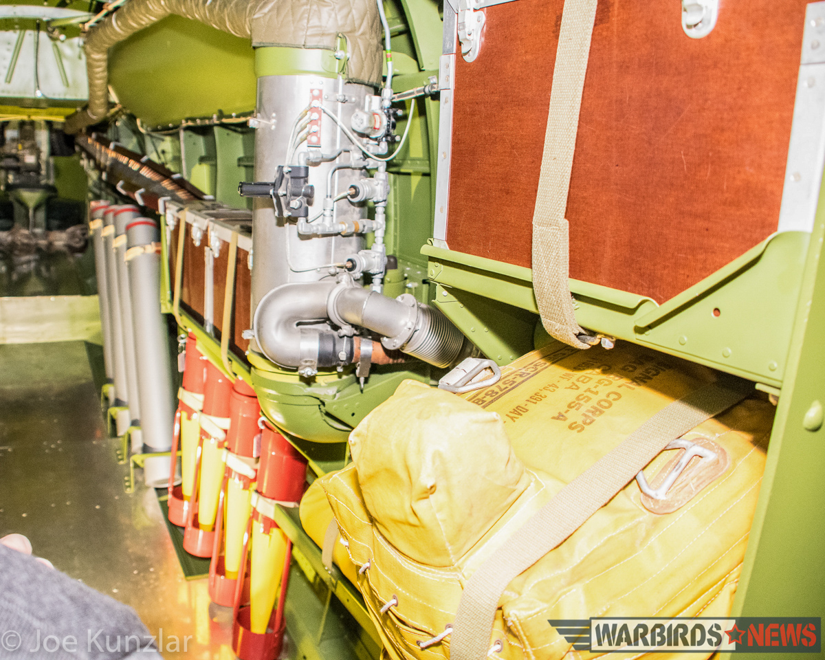 All-Access Tour of FHC's Superb North American B-25J Mitchell 16 A view inside the rear fuselage where you can see the orange and yellow-painted flares, the yellow bulk of the stowed life raft, and the ruddy brown of the phenolic ammunition container. (photo by Joe Kunzlar)