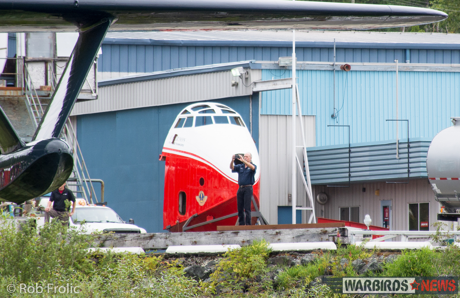 Martin Mars Movements - The Ultimate Flying Experience! 14 Kermit Weeks filming Philippine Mars going into the waters at Sproat Lake. A spare forward fuselage is seen in the background. (photo by Rob Frolic)
