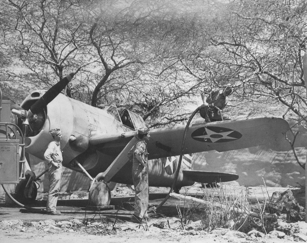 Ghosts of Pearl Harbor: Saving the Crossroads to Marine Aviation in the Pacific Theater 18 A Brewster F2A Buffalo being refueling at Ewa in May, 1942. Note the attempt to hide the aircraft under the thorny Kiawe trees and the sandbag revetment in the background.