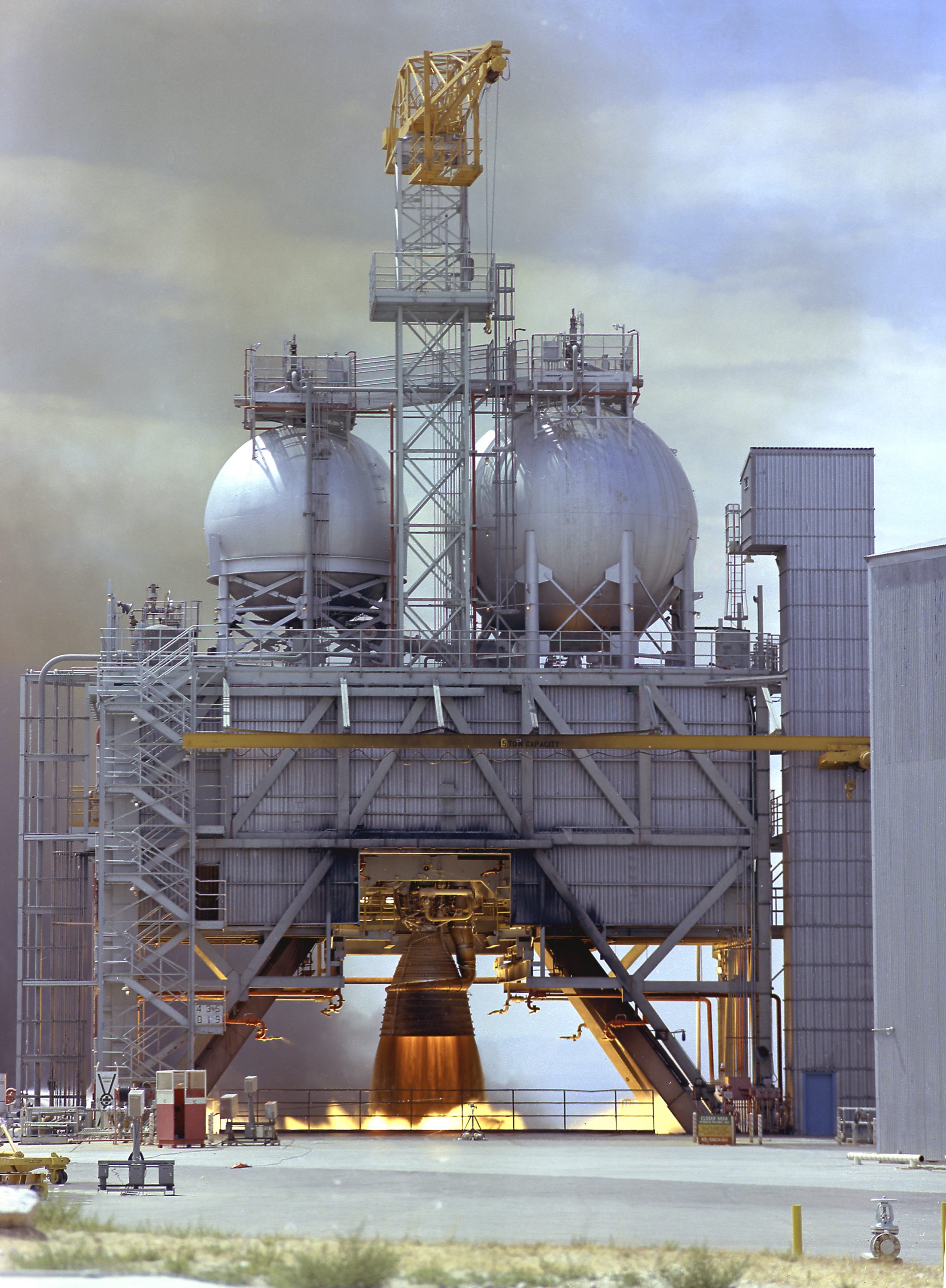Major Installation in New APOLLO Gallery 11 Test Firing of an F-1 Engine at Edwards Air Force Base in 1960. The F-1 engine was developed and built by Rocketdyne under the direction of the Marshall Space Flight Center. It measured 19 feet tall by 12.5 feet at the nozzle exit, and produced a 1,500,000-pound thrust using liquid oxygen and kerosene as the propellant. The image shows an F-1 engine being test fired at the Test Stand 1-C at the Edwards Air Force Base in Californoa. Photo via Wikipedia.