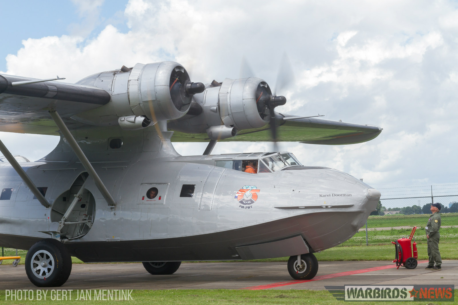 The World’s Oldest Flying PBY Catalina 13 PH-PBY's Pratt & Whitney R-1830's have just been fired up and need some warming before take-off. One of the Catalina Association volunteer keeps an eye on their condition. The inevitable fire extinguisher within reach! (Gert Jan Mentink)