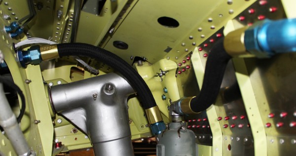 XP-82 Twin Mustang Restoration - February 2014 Update 18 A glimpse inside the wheel well at the freshly installed fuel lines. The hoses lead into the grey-colored C-4 fuel strainer at the bottom center of the image. The silver-painted main undercarriage pintle can be seen just behind the left-most fuel line. (image via Tom Reilly)