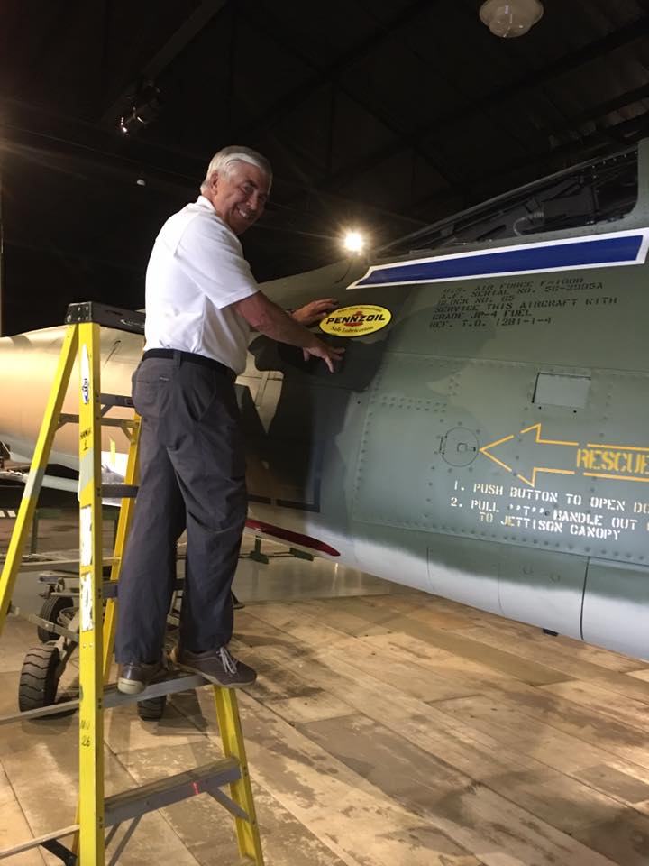 Museum of Aviation F-100 Super Sabre Goes on Display 24 Gen Goddard applying the famous Penzoil sticker.