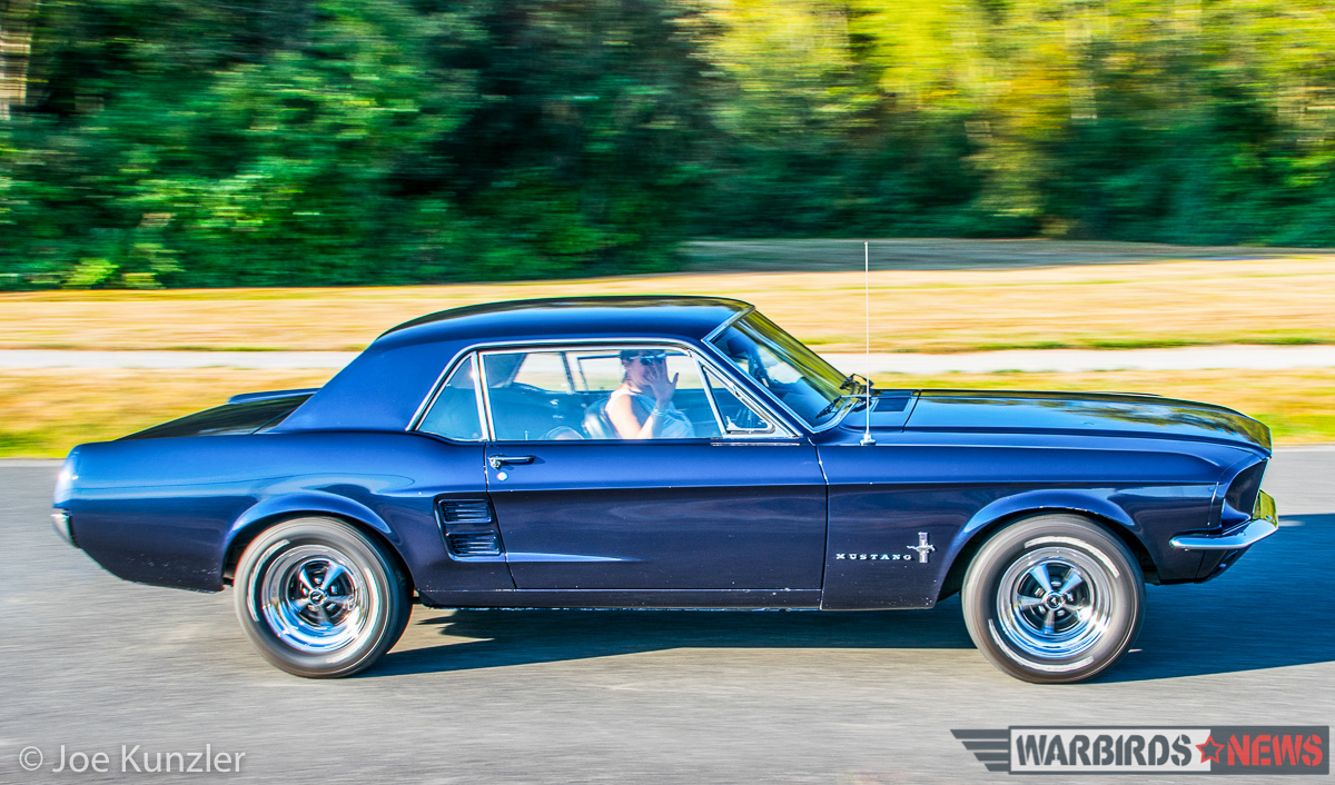 Props & Ponies at the Heritage Flight Museum - Air Show Report 11 HFM Volunteer Tina Shields' 1967 Blue Ford Mustang Heading Into HFM. (photo by Joe Kunzler)