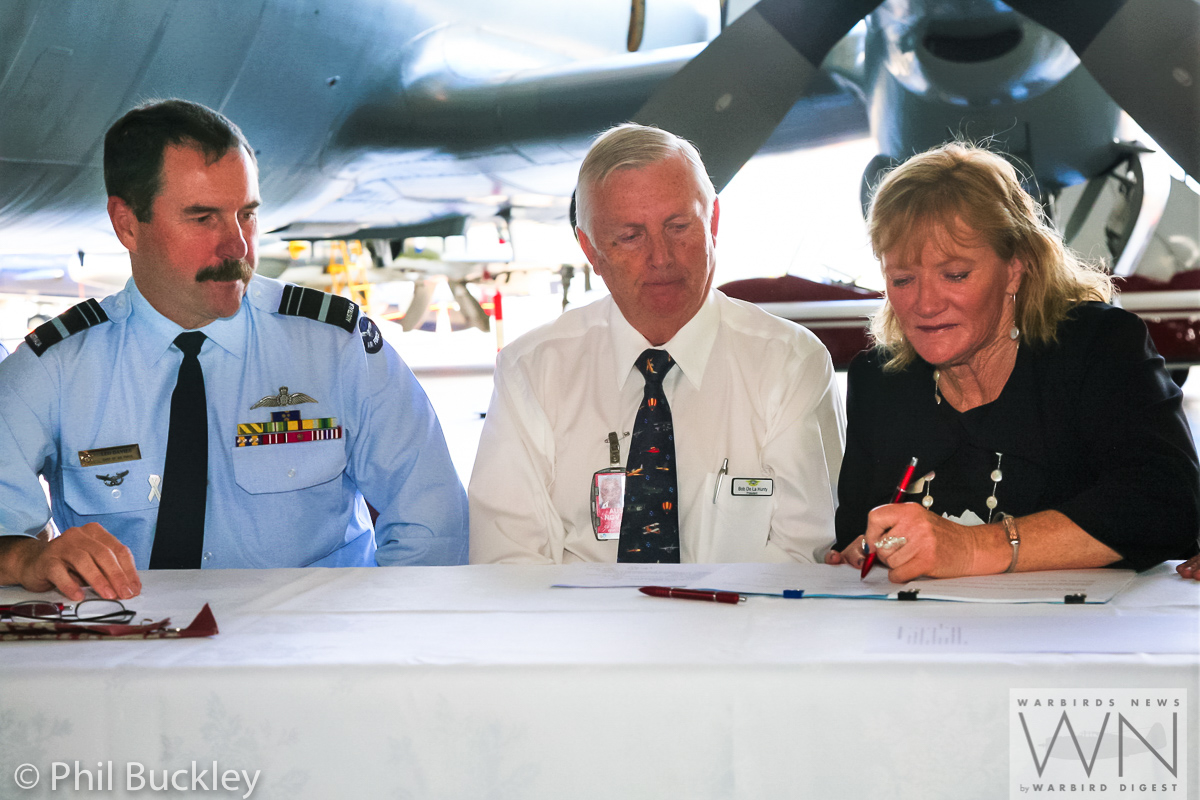 Former RAAF Lockheed Orion Officially Handed Over to HARS 16 Signing the handover documents. (photo by Phil Buckley)