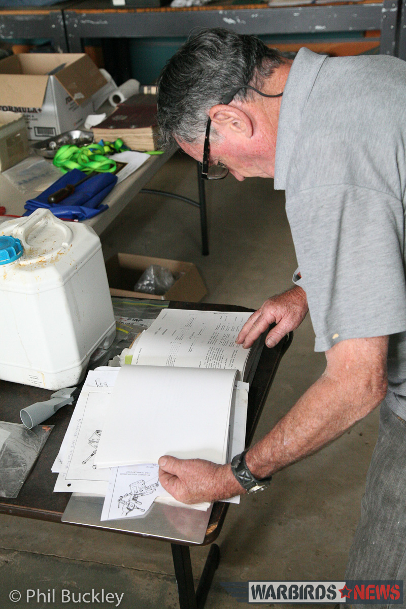 Twin Pin Revival - A Classic Warbird Transport Comes Back to Life Down Under 11 Chief Engineer Johnny Land consults a Twin Pioneer manual. (photo by Phil Buckley)
