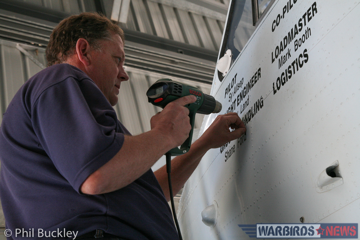 Twin Pioneer Restoration Update from Downunder 23 Richard Thompson using a heat gun to remove the old aircrew stenciling from the cockpit side. (photo by Phil Buckley)