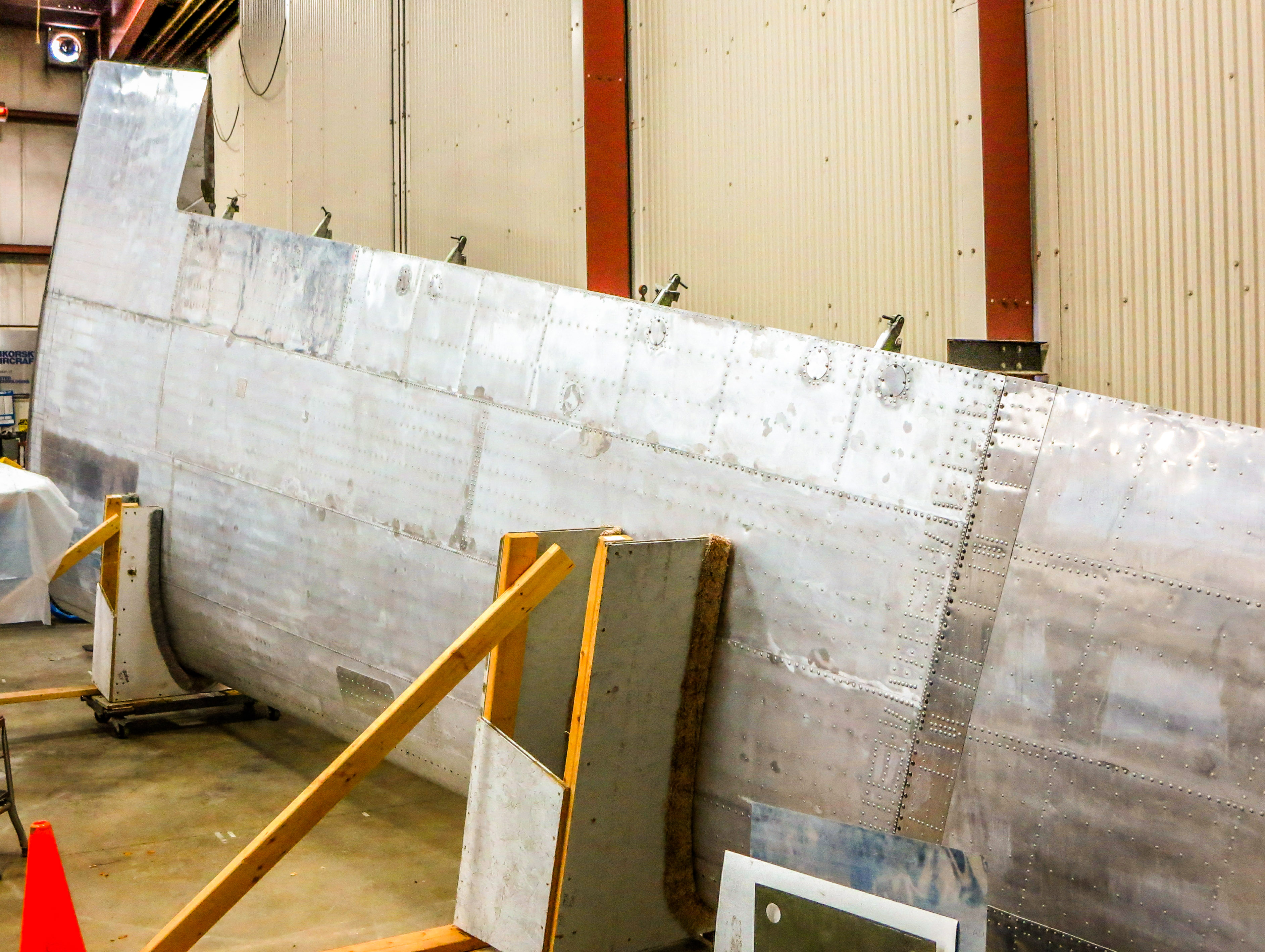 New England Air Museum - DC-3 Restoration Update 11 The left wing is now inside the restoration building. (photo via NEAM)