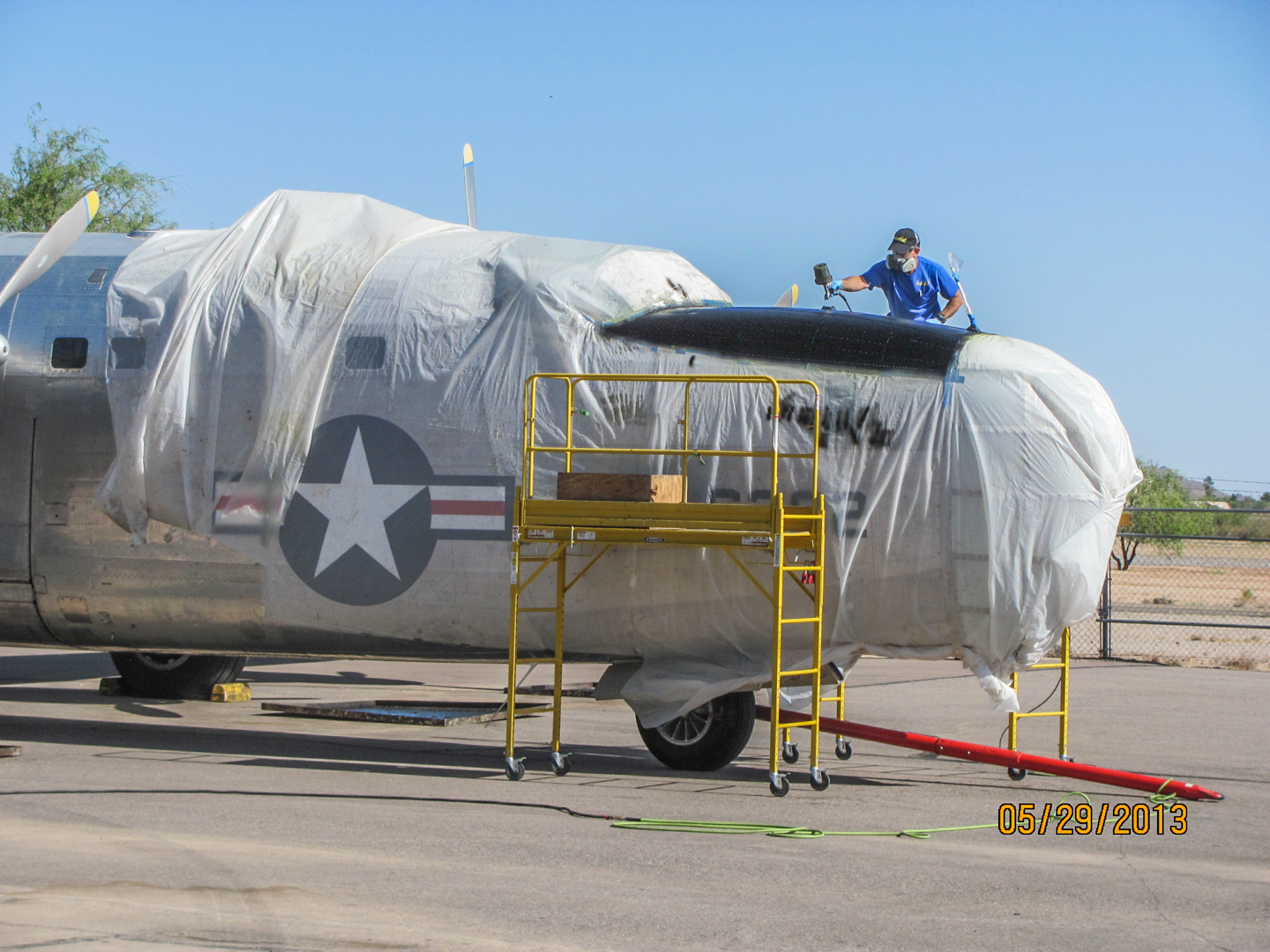 Privateer Airborne 13 The anti-glare paint going on in front of the cockpit following the paint stripping in 2013. (GossHawk Unlimited photo)