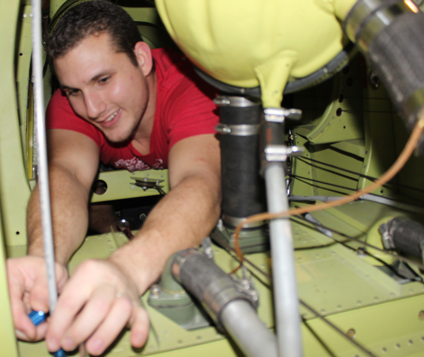 XP-82 Twin Mustang - December 2016 - Restoration Update 16 Routing the oxygen tubing was tight work in places, as is demonstrated ably here by Josh, who is working a line around the coolant header tank. (photo via Tom Reilly)