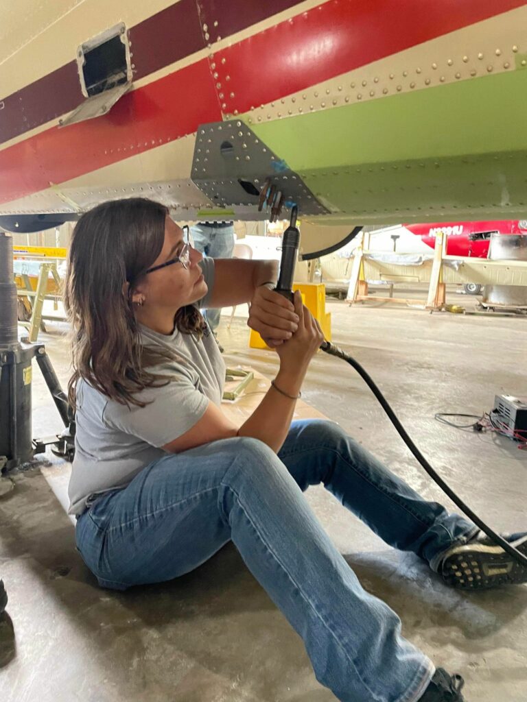 Restoring Jackie Cochran's Twin Beech 12 Kaitlin Mroz shooting rivets in belly repair